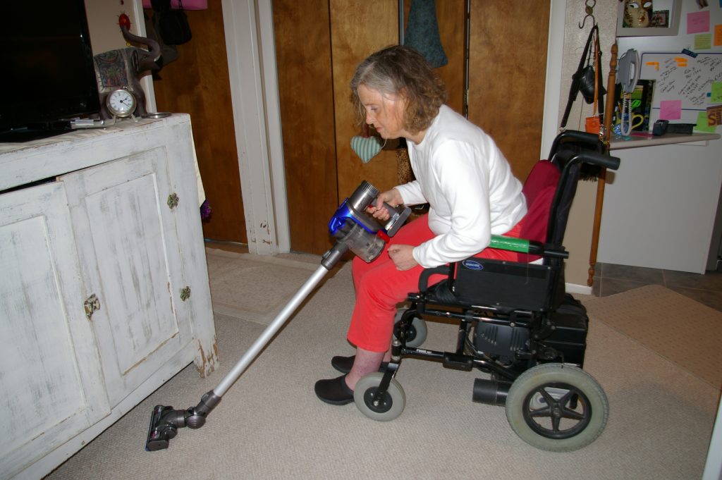 Independent Living Skills Featured Image | Woman in Wheelchair Using Vacuum