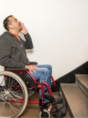 ADA Compliance Page Featured Image | Image of Man in Wheelchair at Bottom of Stairs